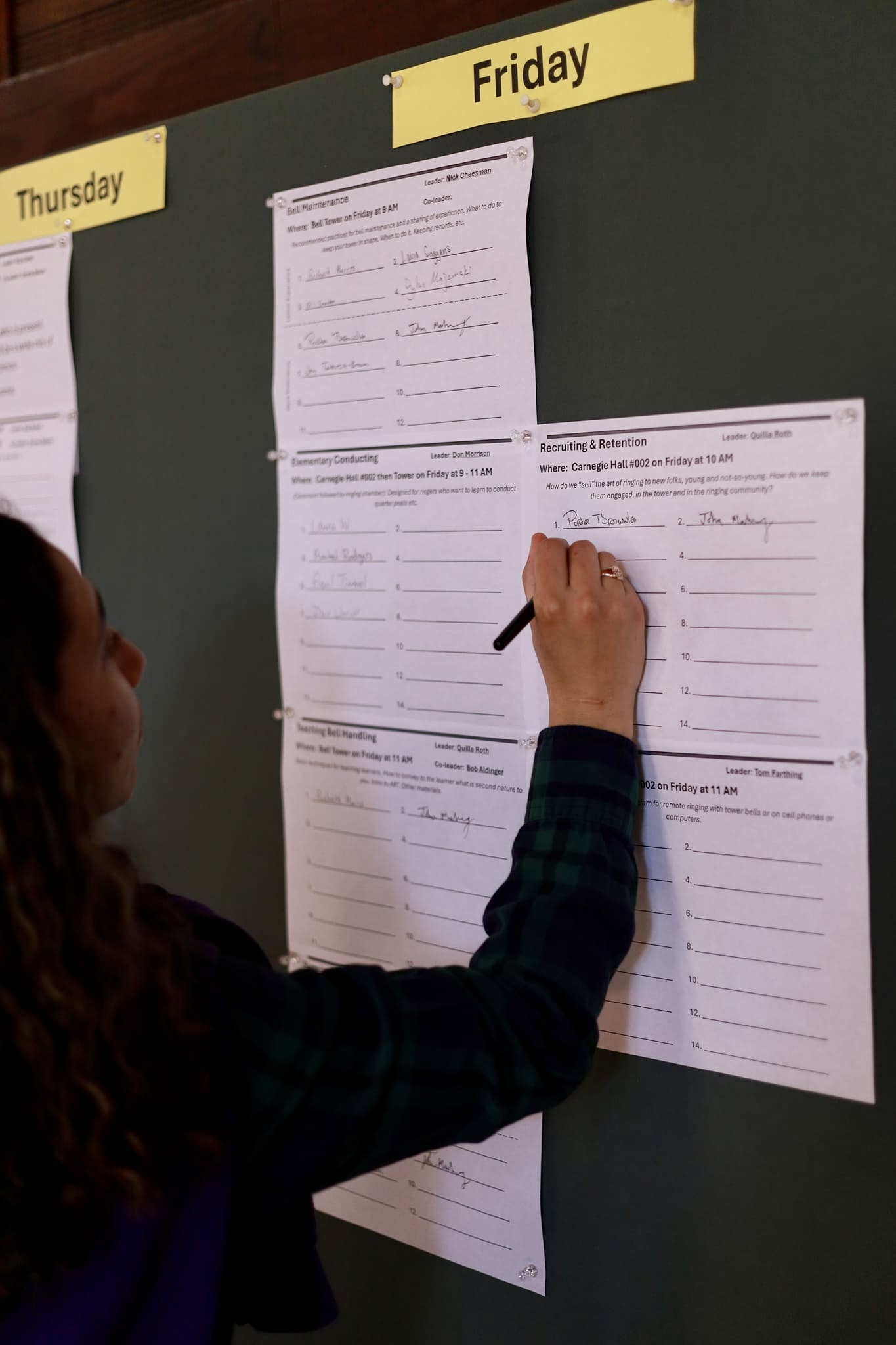 photo of a bell ringer registering for different activities at the annual general meeting in convocation hall