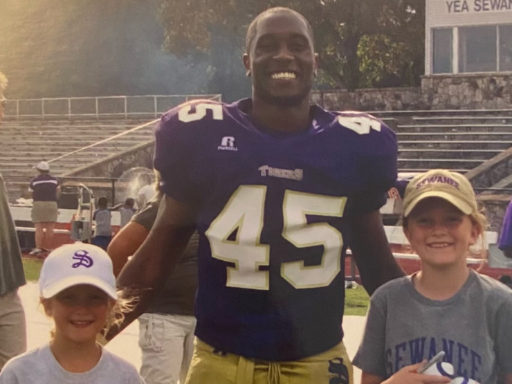Knight with a couple of young fans on Hardee-McGee Field