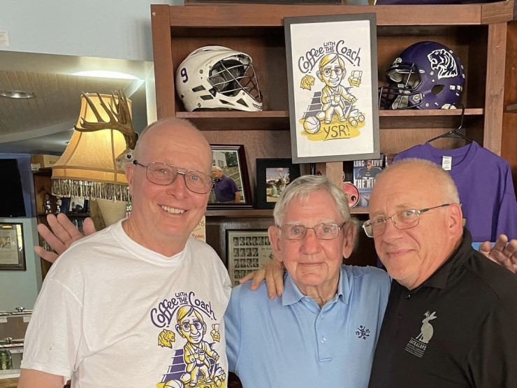 During his trip to the Mountain in 2022, Coach Dennis Meeks (center) visited The Blue Chair and shared a drink with Harper (top left); Jimmy Wilson, C'73, P'01, P'23 (far right); and other friends. Meeks started the popular "Coffee with the Coach" tradition in 2013.