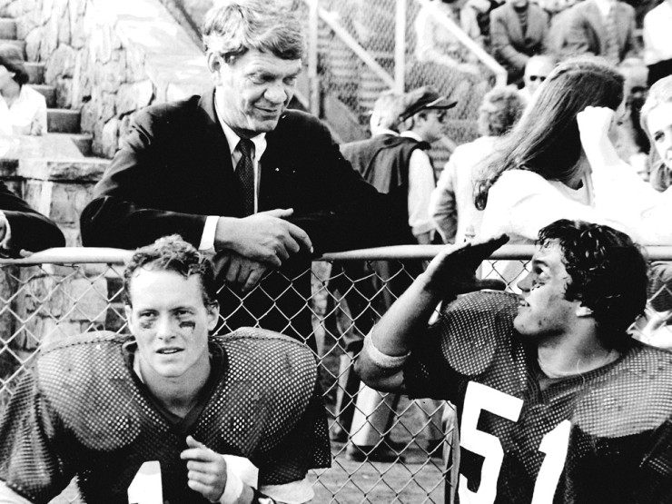 Moose (#51) in conversation with his father, Ashton Phillips, P&rsquo;83, while seated next to Hunter Keller, C&rsquo;82. 'Back in that day, football spectators dressed up a bit,' Moose says. 'My parents came to just about all of our home games.'