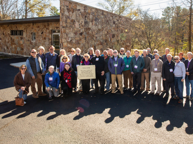 In 2024, Class of 1973 alumni gathered at the Sewanee Welcome Center while it was still under development. Nan Tucker Jennings, C'73, holds a sign describing the Class of 1973's significance as Sewanee's first class to welcome women as full-time undergraduates.