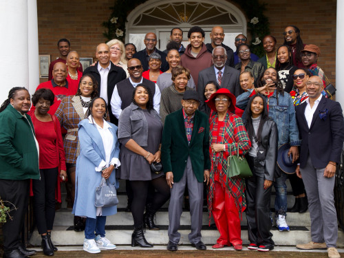 Satcher (top right corner, in green) with aunts, uncles, and cousins at a holiday gathering