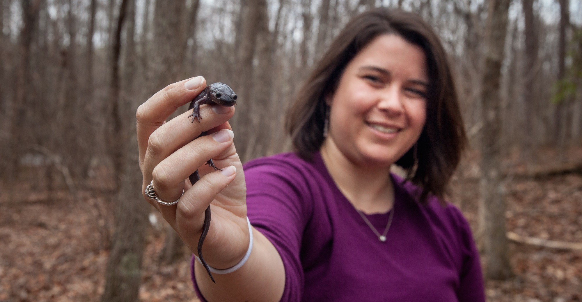 Kristen Cecala and one of her research subjects: a spotted salamander.