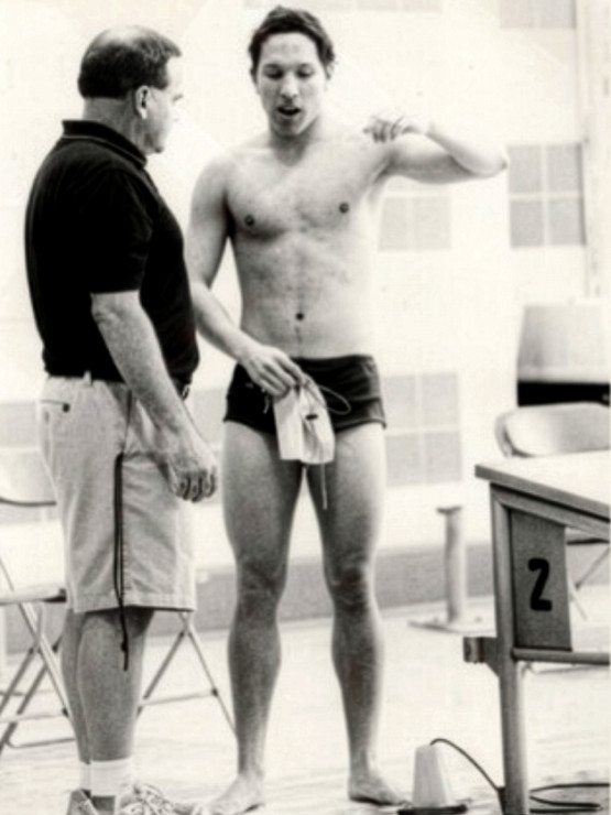 Richards talking with former head swimming and diving coach Max Obermiller, P'14, after a race in 2011.