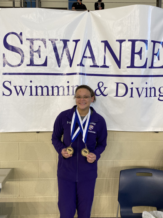 Simmons displays the medals she won at the SAA Conference Championships in 2021