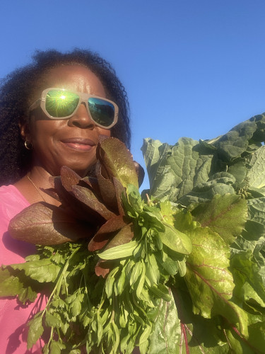 Satcher with leafy greens from her plot in the Dunwoody Community Garden