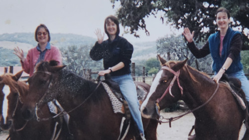 Terri (right) with her twin sisters, Janette Taylor Wojciak, C'78 (left), and Carol Taylor Worsham, C'78 (middle), visiting a dude ranch in 1998